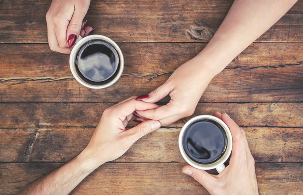 Tazas con un café en manos de hombres y mujeres. Enfoque selectivo. - Foto, imagen