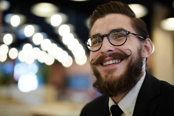 Happy businessman in eyeglasses on night city background - Foto, imagen