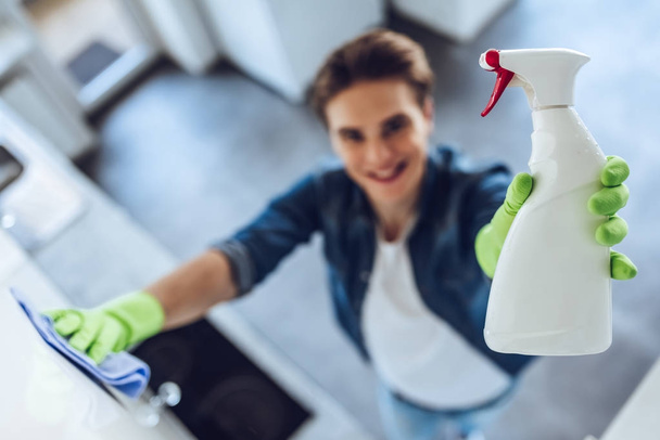 Young man is doing cleaning at home - Fotoğraf, Görsel