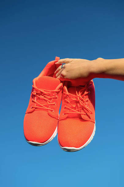 Sports shoes sneakers on blue sky background. - Φωτογραφία, εικόνα