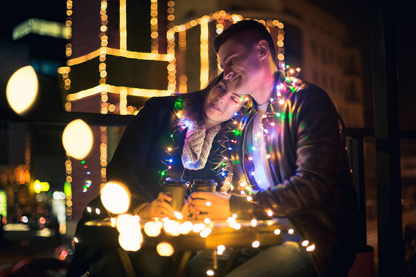 Young couple kissing and hugging outdoor in night street at christmas time - Foto, Imagem