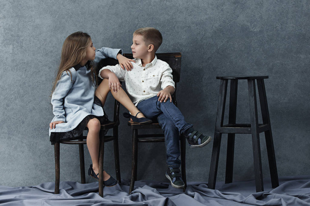A portrait of little girl and a boy on the gray background - Zdjęcie, obraz