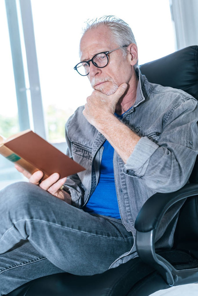 Portrait of mature man reading a book - Foto, imagen