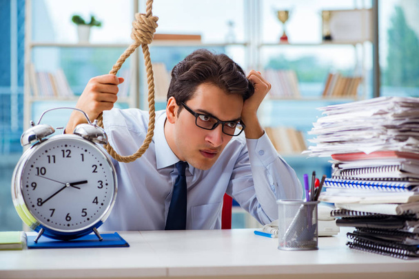 Unhappy businessman thinking of hanging himself in the office - Photo, Image