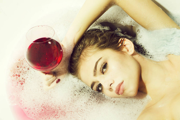 Closeup of woman with glass in bath - Fotó, kép