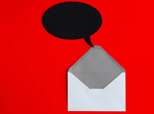 Picture of white envelope and empty black bubble over red backgr - Foto, Imagen