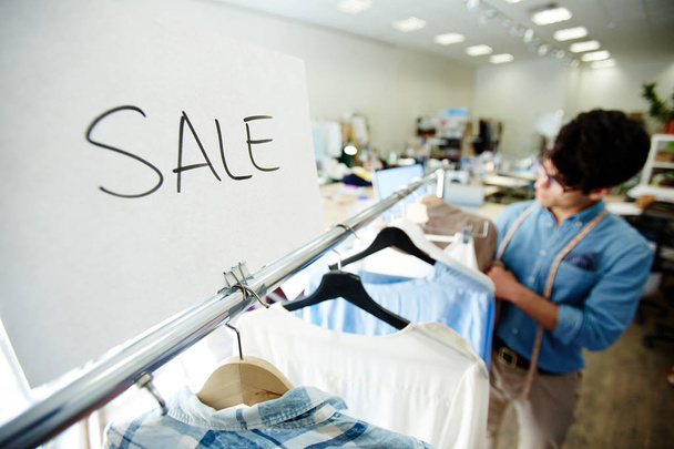 Paper saying about sale of stylish casual clothes in tailoring shop - Photo, Image