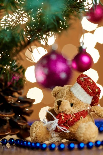 A composition of New Year's toys on the background of Christmas trees and garlands - Fotografie, Obrázek