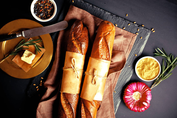 Bread and pastries in a composition with kitchen accessories on an old background - Photo, Image