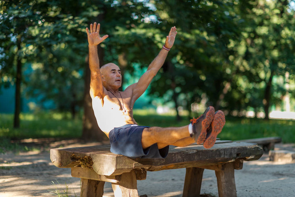 Senior male exercising outdoors in public park - Φωτογραφία, εικόνα