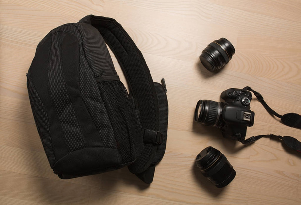 Photographer's small backpack with digital slr camera and replac - Foto, afbeelding