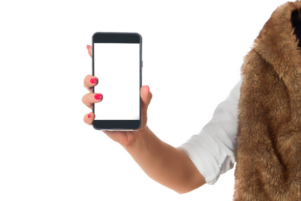 Телефон в руке, который держит женщина. Женщина в пиджаке с корнем, белая рубашка держит телефон перед камерой. Пустой экран. Изолированный белый фон
. - Фото, изображение