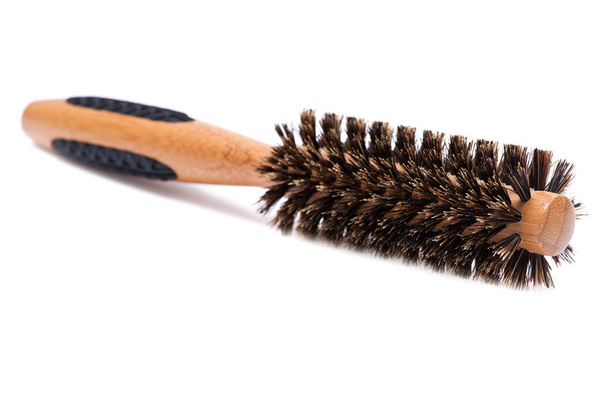 Round natural bamboo hairbrush with wild boar bristles isolated on white background - Fotó, kép