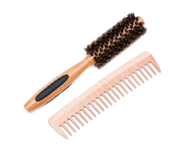Round natural bamboo hairbrush with wild boar bristles and wooden comb isolated on white background - Photo, Image