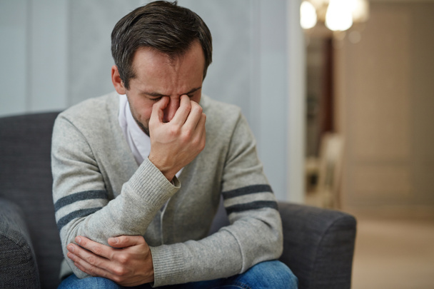 Homem desesperado chorando durante sessão psicológica
 - Foto, Imagem