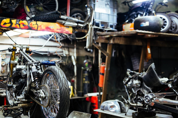 Background image  of disassembled motorcycle ready for repairing in mechanics garage - Foto, Imagem