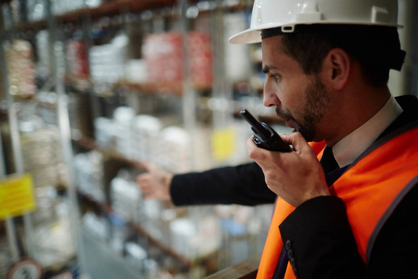 Warehouse supervisor talking in walkie-talkie - Photo, Image