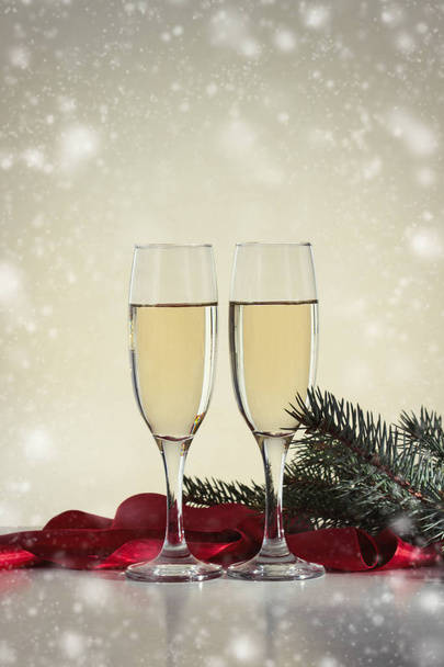 Christmas composition. Two glasses with champagne, spruce branch - Photo, Image