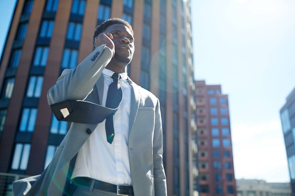 Elegant man in suit and tie calling outdoors - Фото, зображення