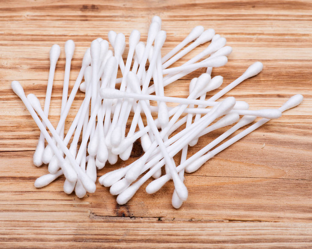 Organic double end cotton ear and make up swabs, buds on wooden vintage background - Photo, Image