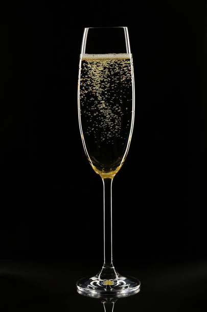 Champagne glass on black background - Фото, изображение