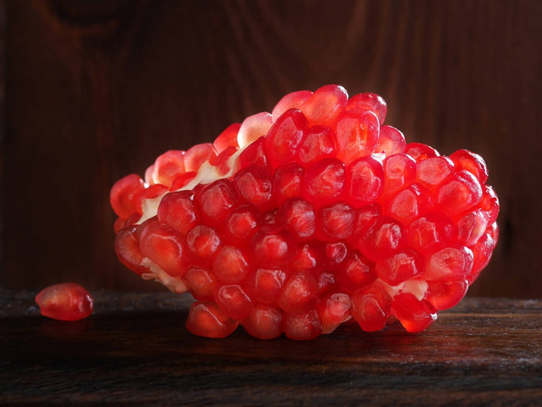 Close up of pomegranate dark wooden background  - Foto, imagen