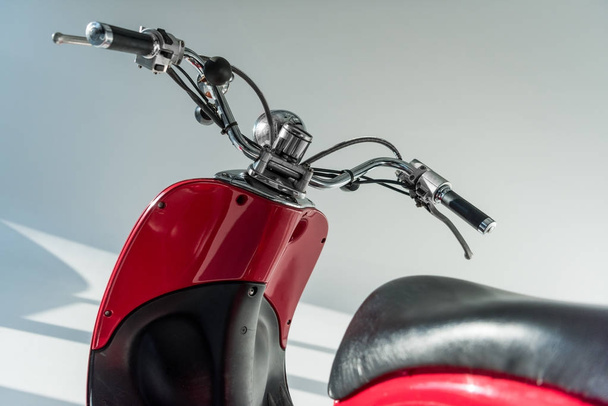 close up view of red vintage scooter in studio - Fotó, kép