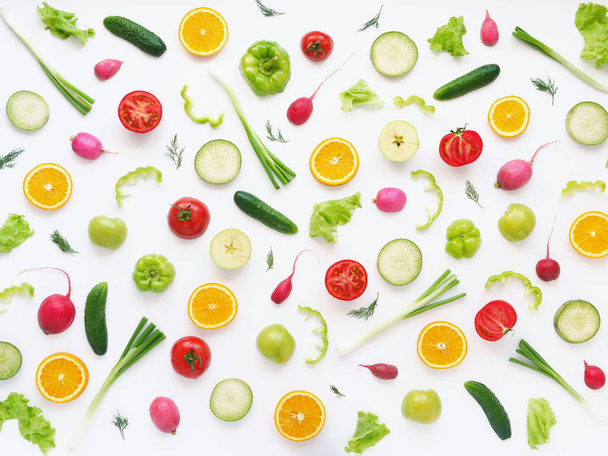 Food composition with radishes, tomatoes, cucumbers, green onions, peppers, oranges and dill isolated on white background - Photo, Image