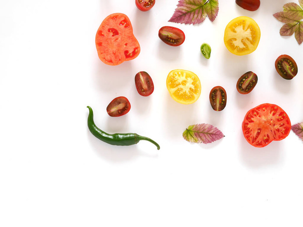 Food collage of tomatoes in a cut, pepper, autumn leaves isolated on white background - Foto, Bild