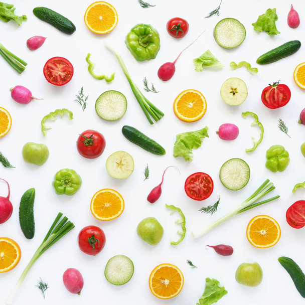 Food composition with tomatoes, peppers, radishes, cucumbers, green onions, zucchini, oranges and dill isolated on white background - Photo, Image