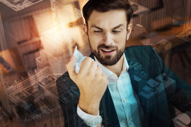 businessman in a suit clenching paper - Фото, зображення