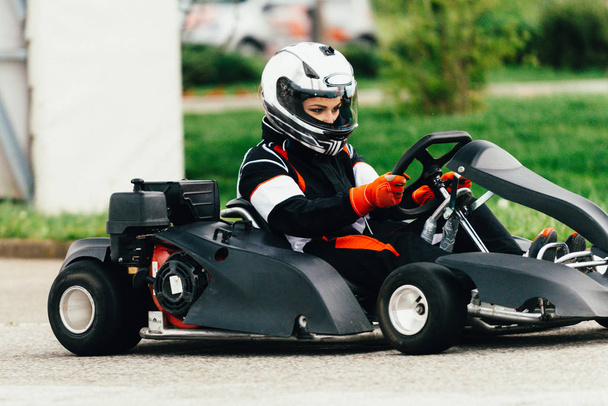 Woman driving go-cart on a sports track - Photo, Image