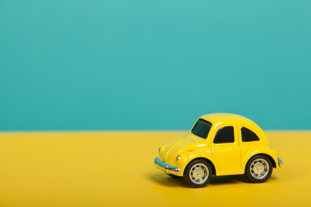 Cute yellow car on green background. Travel concept - Foto, Imagen