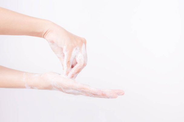 Asian girl hands are washing with soap bubbles on white background - 写真・画像