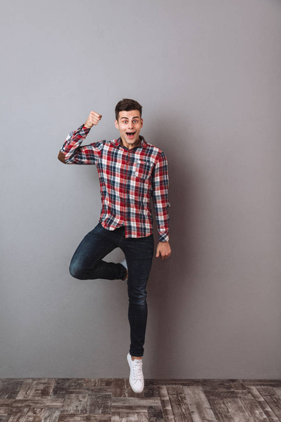 Full-length image of Surprised happy man in shirt and jeans - Zdjęcie, obraz