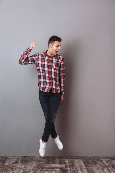 Full length image of Cheerful man in shirt and jeans - Valokuva, kuva