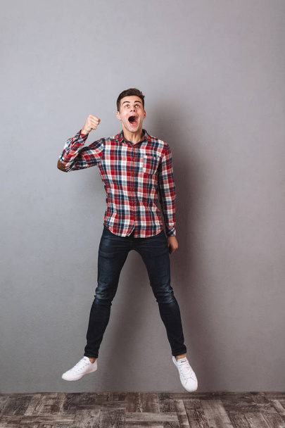Full length image of Screaming man in shirt and jeans - Фото, изображение