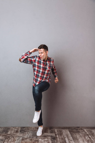Full length image of Pleased man in shirt and jeans - Foto, imagen