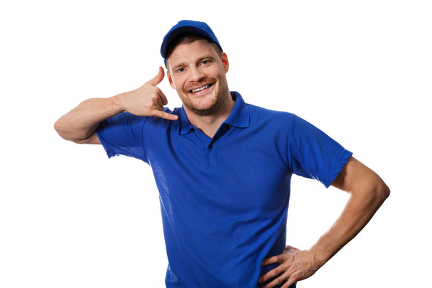 serviços de faz-tudo - trabalhador de uniforme azul fazendo gesto telefonema
 - Foto, Imagem