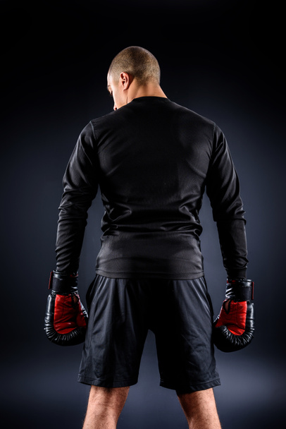 back view of african american boxer in gloves on black - Photo, Image
