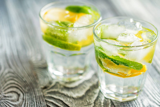 Lemonade or mojito cocktail with lemon and mint - Fotoğraf, Görsel