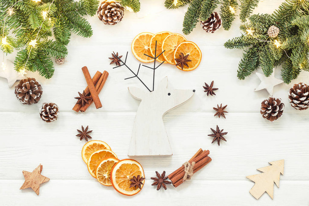 Christmas or New Year decoration background with fir branches, orange, cinnamon sticks, anise. - Foto, Bild