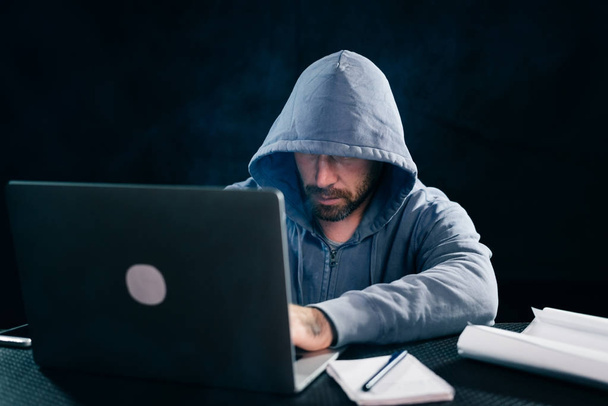 A computer hacker is typing on the keyboard. Dark background - Photo, Image