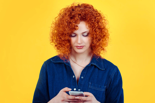 I received a message. Pretty redhead curly woman texting talking on mobile phone sending a message isolated yellow background. - Foto, Imagem