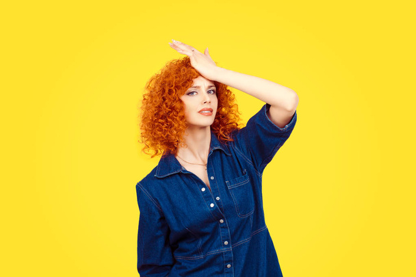 Regrets wrong doing. Closeup portrait silly young redhead curly woman slapping hand on head having duh moment isolated yellow background Negative human emotion facial expression body language reaction - Photo, image
