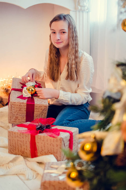 Teenage girl opening the present - Photo, Image