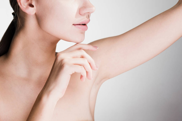 beautiful young girl showing her armpits after depilation - 写真・画像