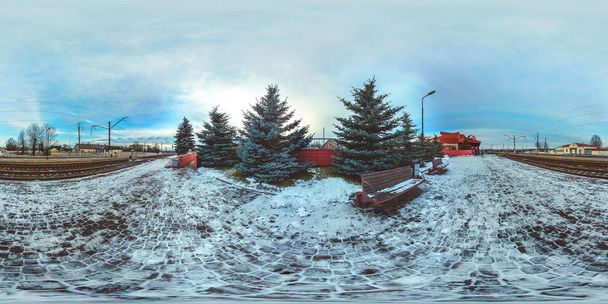 3D spherical panorama with 360 viewing angle.  Ready for virtual reality or VR. Full equirectangular projection. Winter landscape with snow and fir-trees. Cold blue sunset at train station. - Photo, Image