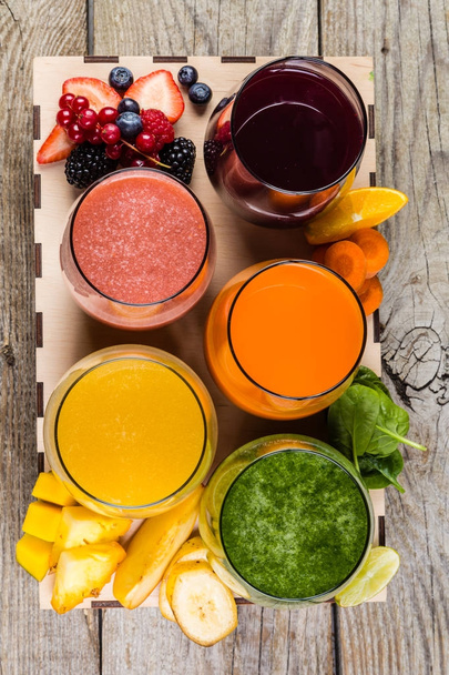 Selection of colourful smoothies on rustic wood background - Foto, afbeelding