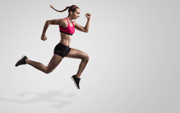 young woman running and jumping - Фото, изображение